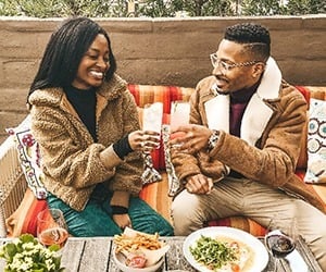 A couple toasting over lunch