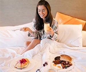 A woman enjoying room service