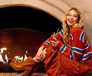 A woman by the fireplace