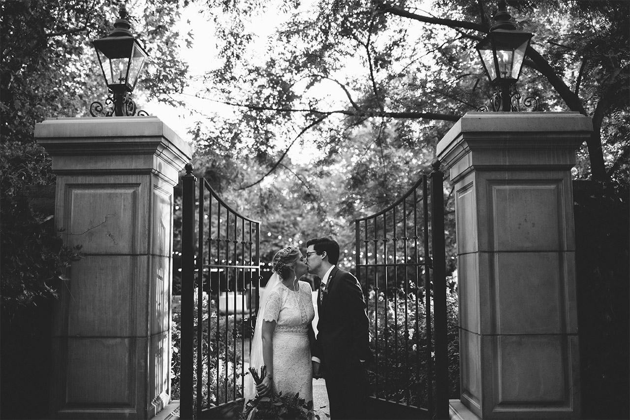 Black and white photo of married couple kissing
