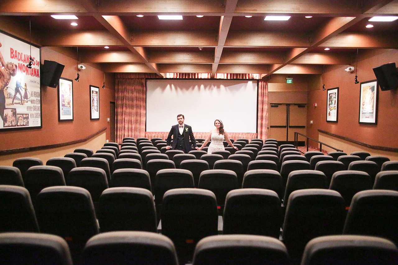 A bridal couple standing in a theatre
