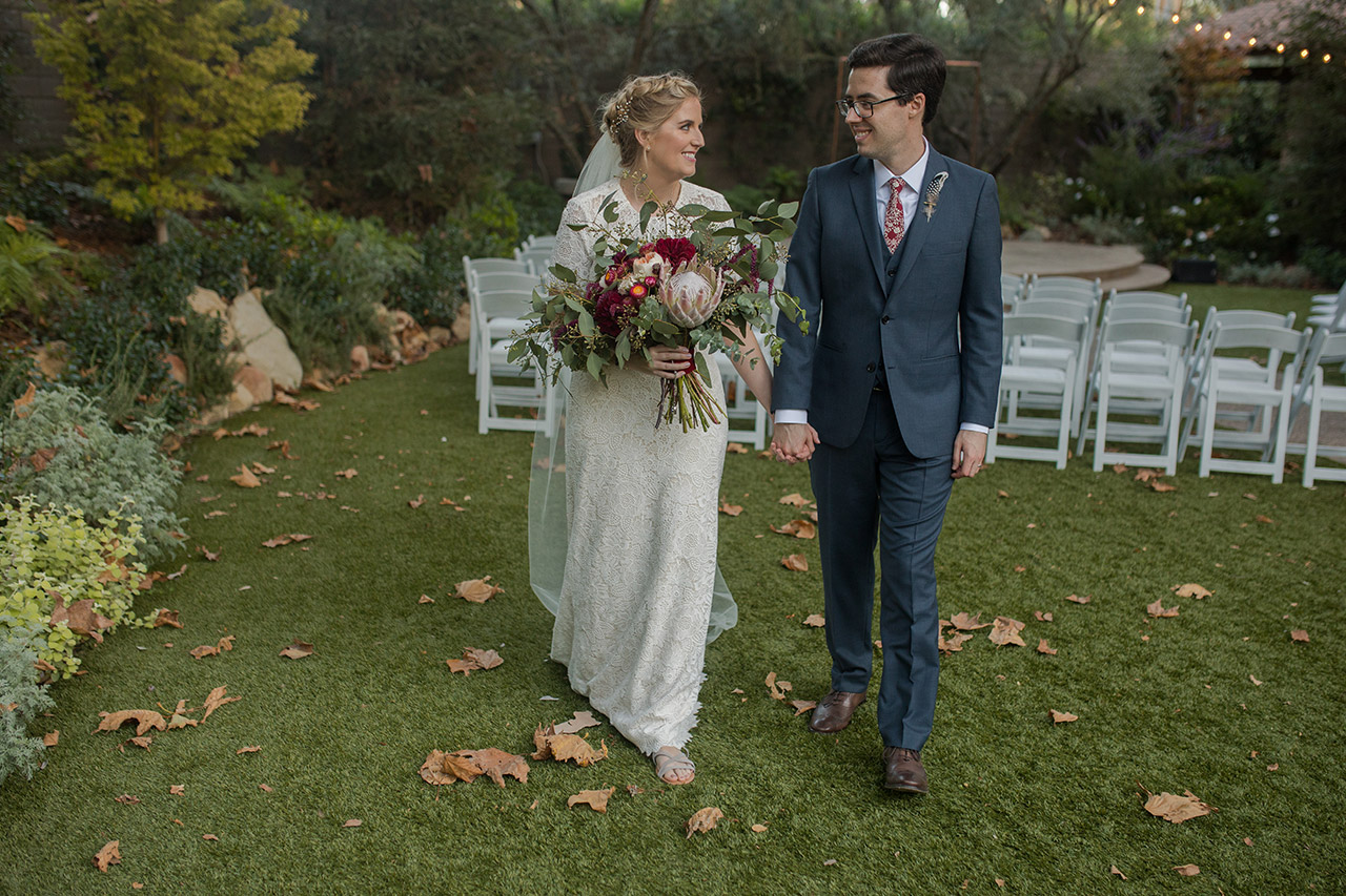 A bridal couple holding hands