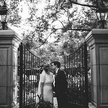 Black and white photo of married couple kissing
