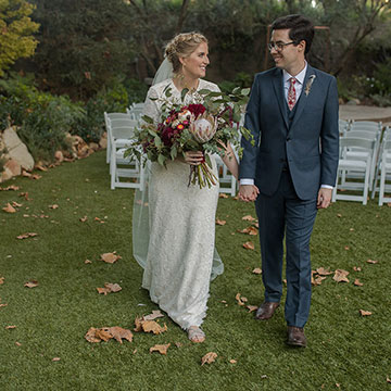 A bridal couple holding hands
