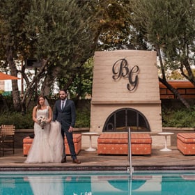 Bride and groom by pool